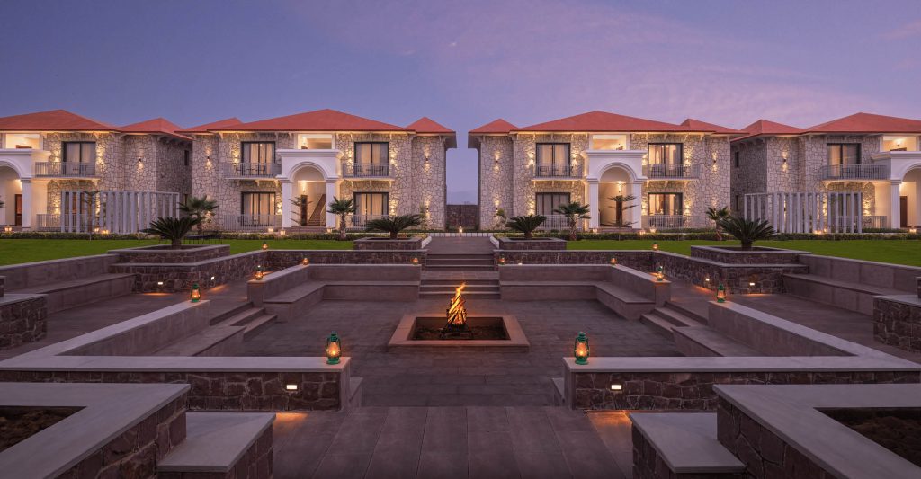 Outdoor fire pit area with luxurious stone architecture at Bookmark Resorts, Jogi Mahal, Ranthambore