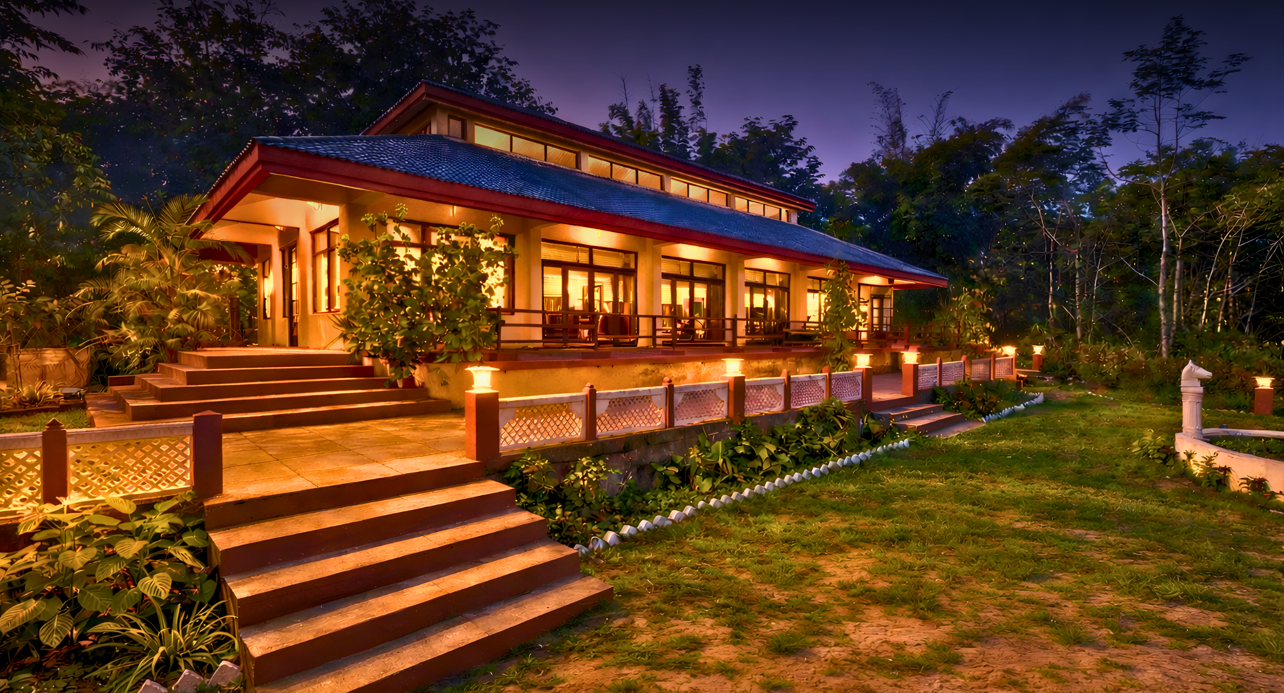 Night view of a warmly lit bungalow with large glass doors, wooden steps, and tropical garden at dusk.